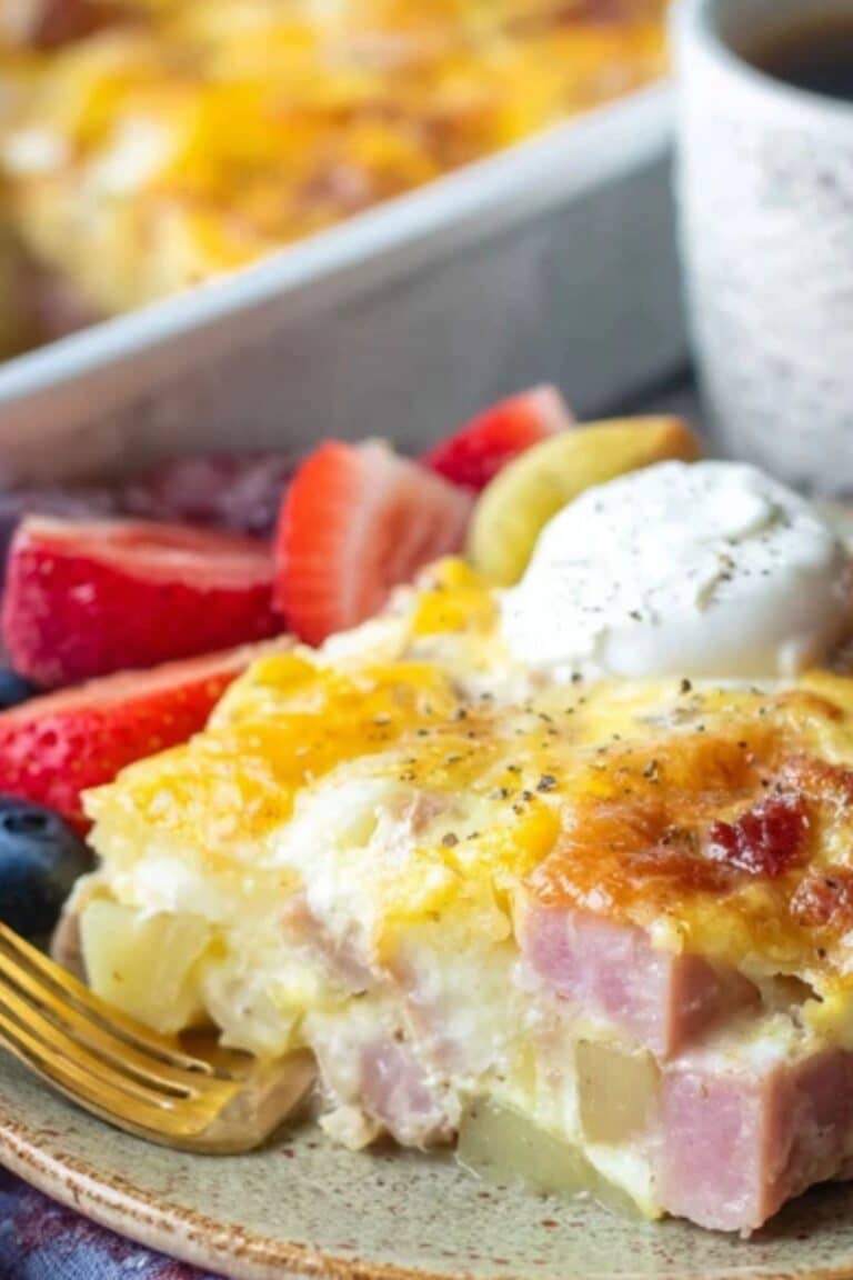 Ham and Potato Breakfast Casserole served hot in a white baking dish on a rustic table