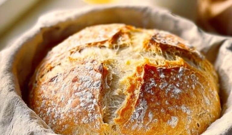 Dutch Oven No Knead Bread rustic loaf cooling on board