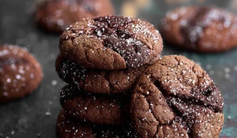 Chocolate Ginger Sparkle Cookies stacked on rustic table