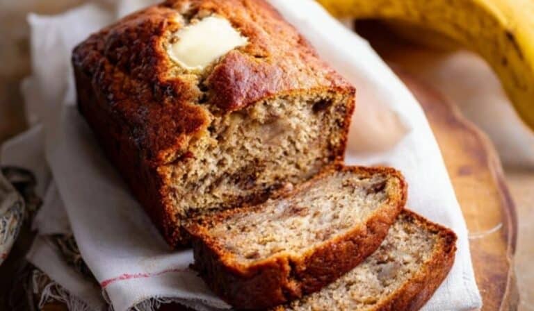 Freshly baked banana bread loaf on rustic kitchen counter