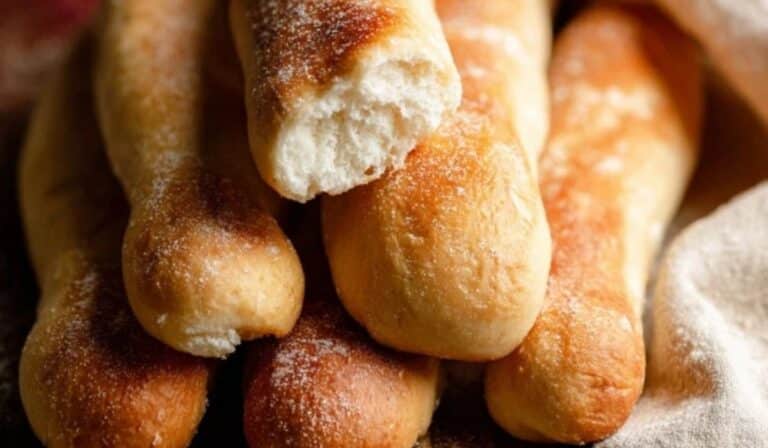 Homemade soft breadsticks on a wooden board
