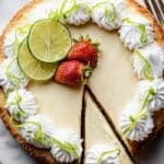 Key Lime Cheesecake slice with whipped cream and lime