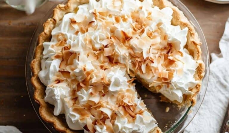 Homemade Coconut Cream Pie topped with whipped cream and toasted coconut