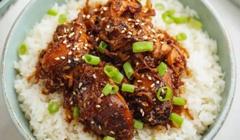 Slow cooker honey garlic chicken with sticky sauce over rice