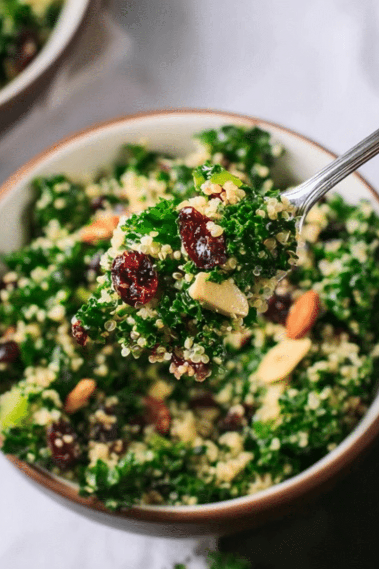 Kale and Quinoa Salad with Crisp Celery, Plumped Cranberries, and Lemon Dressing in a bowl