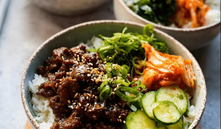 Korean Beef Bulgogi Rice Bowls with glossy beef, rice, kimchi, and cucumbers