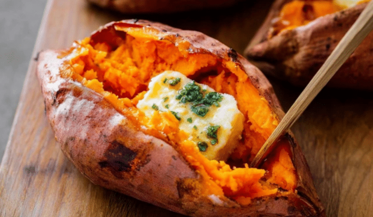 Perfect Baked Sweet Potato split open with fluffy center and butter