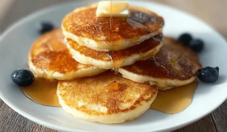 Cottage cheese pancakes stacked high with maple syrup and butter