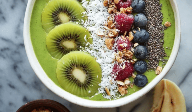 : Super Green Smoothie Bowl topped with kiwi, berries, and granola